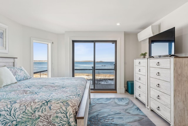 bedroom with a water view, access to exterior, multiple windows, and a wall mounted AC