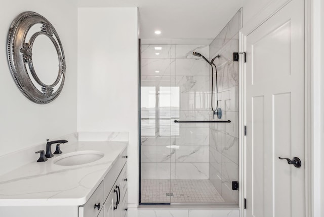 full bathroom featuring a marble finish shower, vanity, and recessed lighting