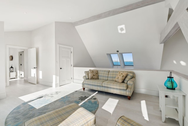 living room with a skylight, baseboards, and high vaulted ceiling