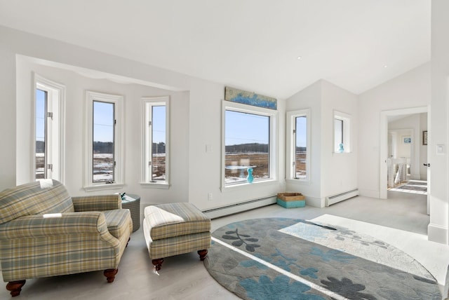 sitting room featuring vaulted ceiling and baseboard heating