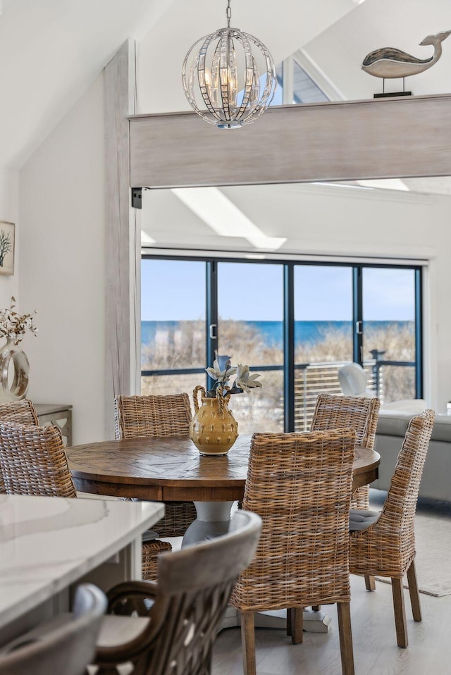 dining room with vaulted ceiling, wood finished floors, and a notable chandelier