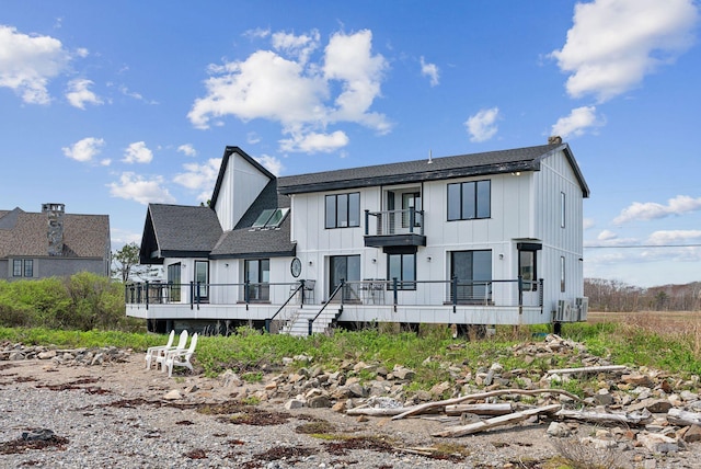 107 Marshall Point Rd, Kennebunkport, ME 04046 - view of front of house with a balcony, a shingled roof, board and batten siding, and a wooden deck