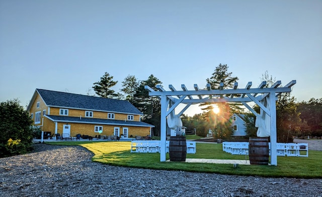 view of property's community featuring a yard and a pergola