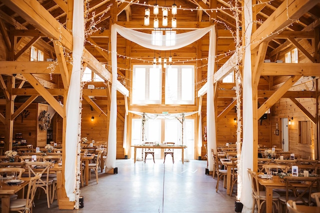 miscellaneous room with wooden walls and a towering ceiling