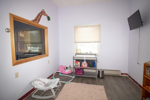 playroom featuring baseboards and wood finished floors