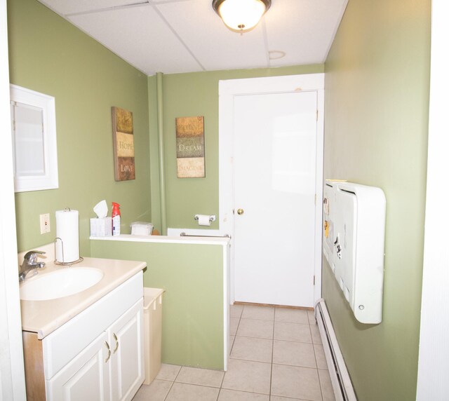 bathroom featuring tile patterned flooring, a baseboard heating unit, and vanity