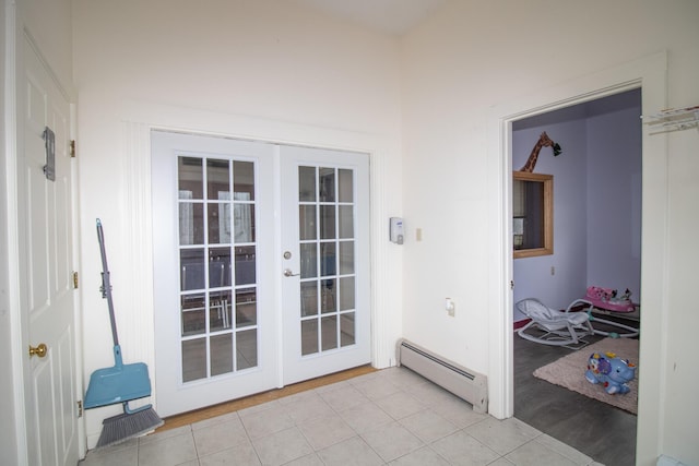 entryway with light tile patterned floors, baseboard heating, and french doors