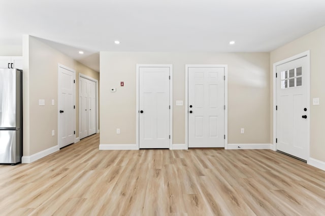 entryway with recessed lighting, light wood-style flooring, and baseboards