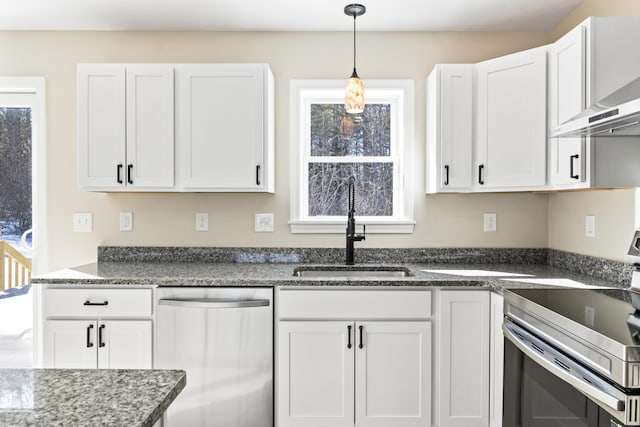 kitchen with appliances with stainless steel finishes, white cabinets, and a sink