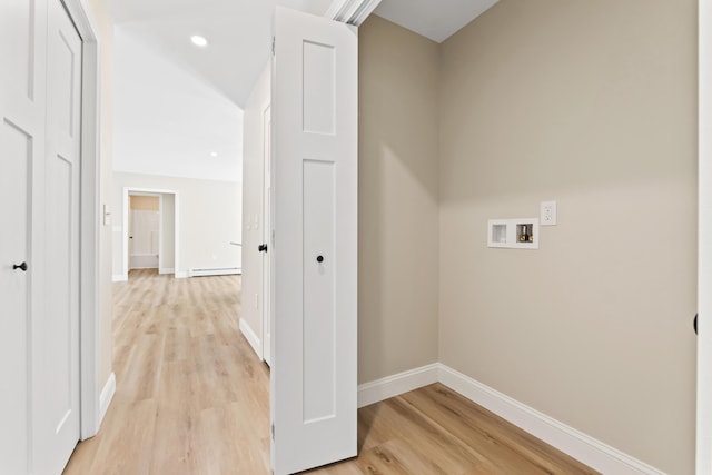 clothes washing area featuring hookup for a washing machine, laundry area, baseboards, baseboard heating, and light wood finished floors