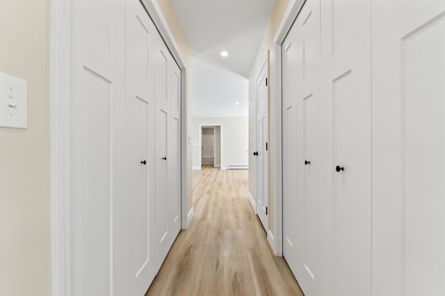 hall featuring light wood-style floors, a baseboard radiator, baseboards, and recessed lighting