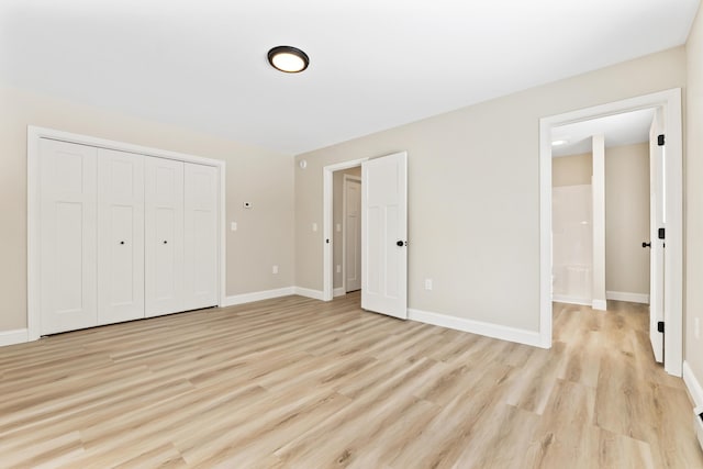 unfurnished bedroom featuring light wood-type flooring, baseboards, and a closet