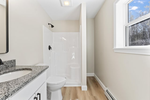 full bath with toilet, a stall shower, vanity, wood finished floors, and baseboards