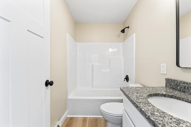 full bath featuring toilet, wood finished floors, vanity, baseboards, and shower / bathing tub combination