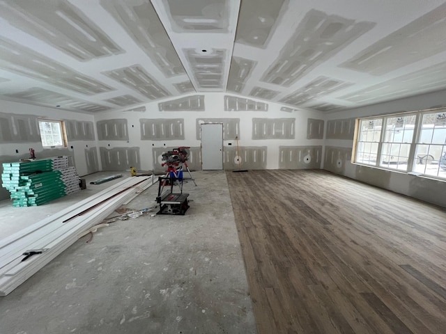 misc room with vaulted ceiling and wood finished floors