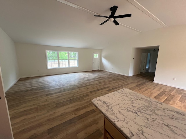 128 Main Street Hl, Dexter, ME 04930 - unfurnished living room featuring lofted ceiling, a ceiling fan, dark wood-style flooring, and baseboards