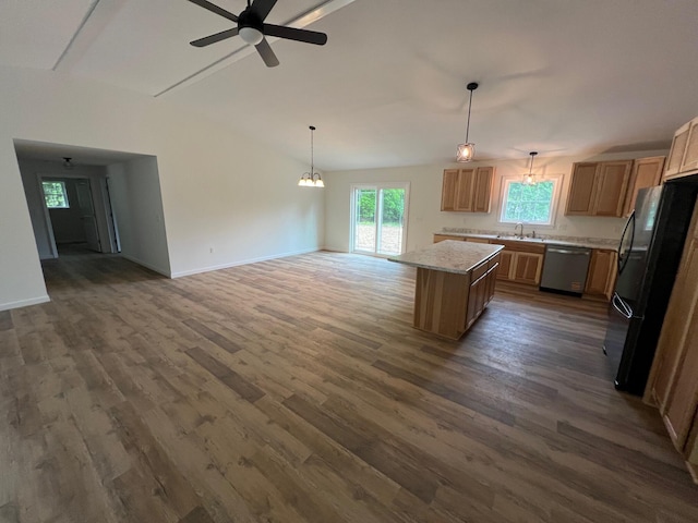 128 Main Street Hl, Dexter, ME 04930 - kitchen with stainless steel dishwasher, freestanding refrigerator, a sink, open floor plan, and vaulted ceiling