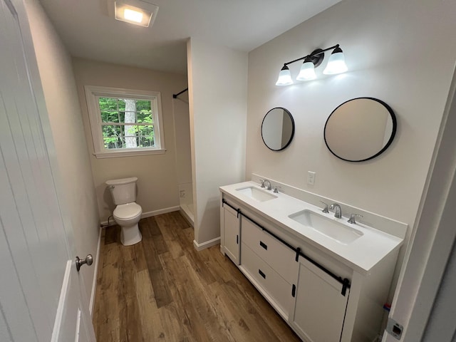 128 Main Street Hl, Dexter, ME 04930 - bathroom with wood finished floors, double vanity, toilet, and baseboards
