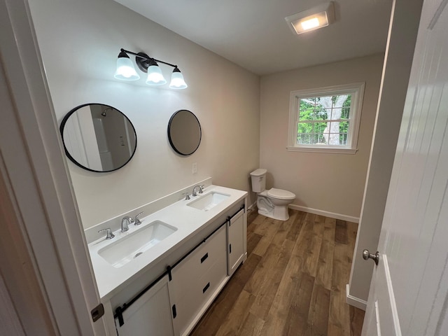 128 Main Street Hl, Dexter, ME 04930 - bathroom featuring double vanity, wood finished floors, toilet, and baseboards