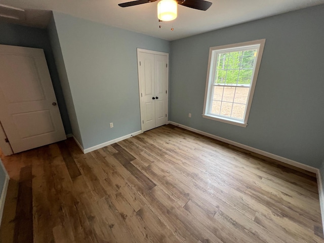 128 Main Street Hl, Dexter, ME 04930 - unfurnished bedroom with wood finished floors, baseboards, a closet, and ceiling fan