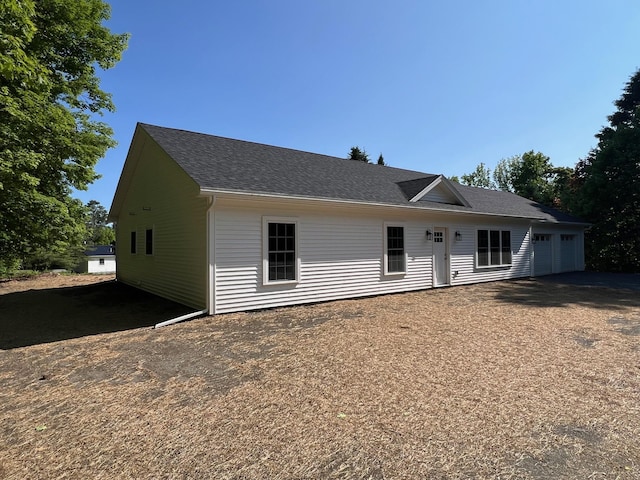 128 Main Street Hl, Dexter, ME 04930 - view of front of property featuring an attached garage, roof with shingles, and asphalt driveway