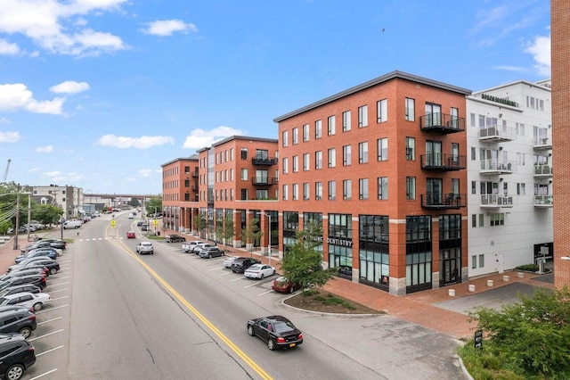 view of building exterior featuring uncovered parking