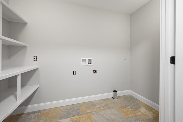 washroom with stone finish flooring, baseboards, hookup for a washing machine, and laundry area