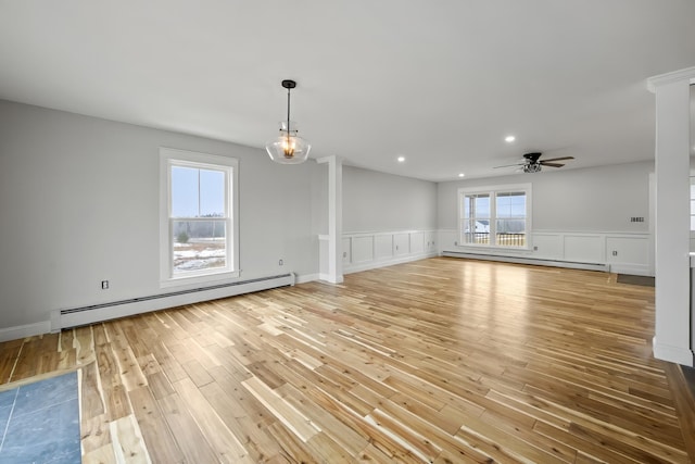 spare room featuring light wood finished floors, baseboard heating, recessed lighting, and ceiling fan