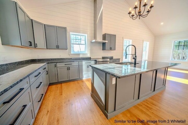 kitchen with light wood-style floors, gray cabinets, stainless steel electric range oven, and a sink