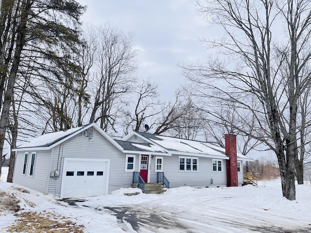 single story home featuring a garage and a chimney