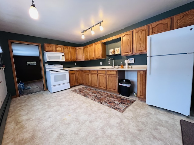 kitchen featuring brown cabinetry, white appliances, light countertops, and a sink