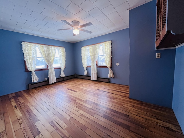 empty room with hardwood / wood-style flooring and a ceiling fan