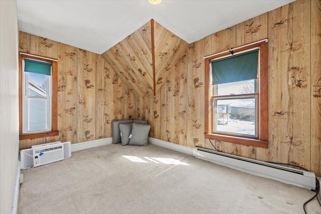 bonus room with carpet floors, a wall unit AC, baseboard heating, wooden walls, and baseboards