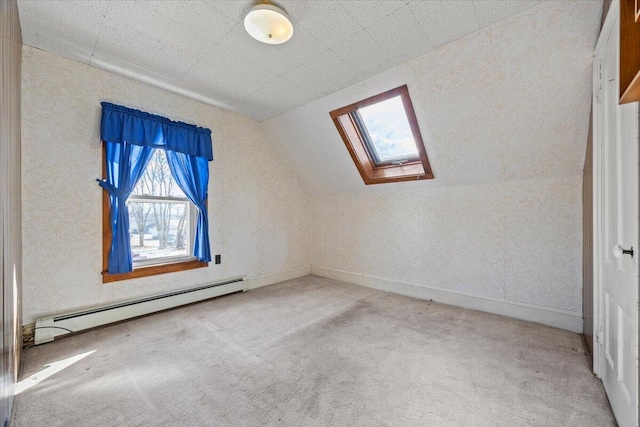 bonus room with vaulted ceiling with skylight, baseboard heating, carpet flooring, and baseboards