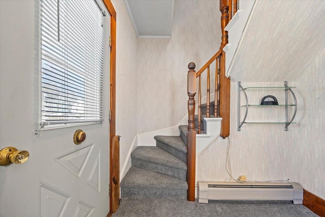 stairs with ornamental molding and a baseboard radiator