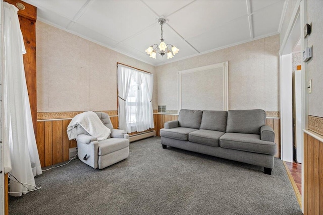 living area featuring a wainscoted wall, carpet floors, baseboard heating, and an inviting chandelier