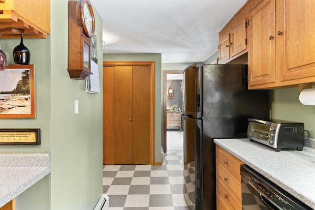 kitchen featuring a toaster, light floors, light countertops, a textured ceiling, and black appliances