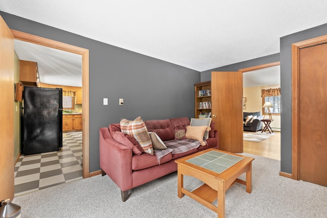 living room featuring light carpet and baseboards