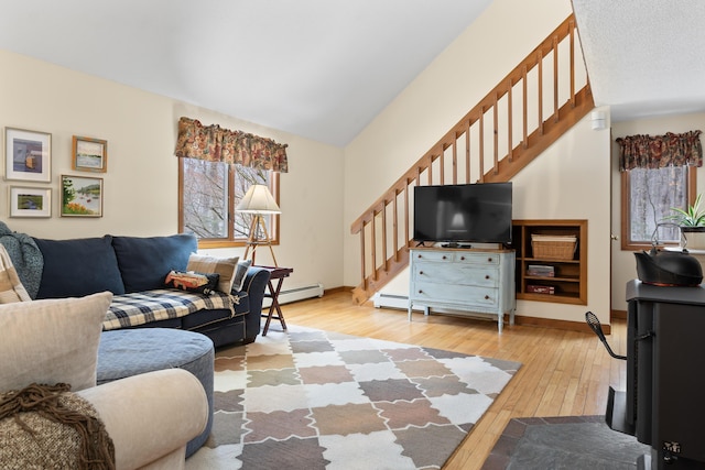 living room featuring light wood-type flooring, stairs, baseboards, and vaulted ceiling