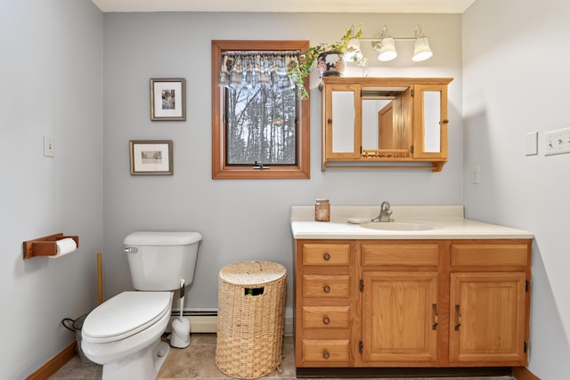 bathroom featuring baseboard heating, vanity, and toilet