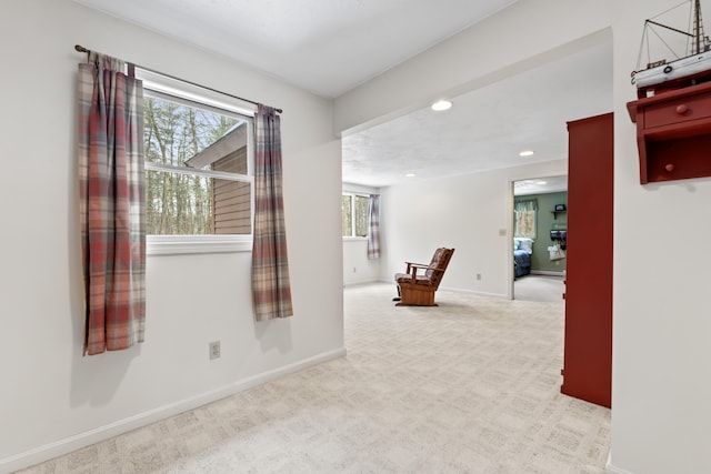 carpeted empty room with baseboards and recessed lighting