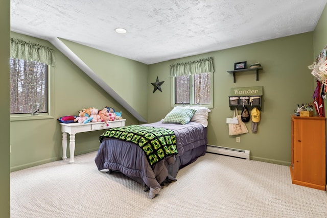 carpeted bedroom with baseboards, a textured ceiling, and baseboard heating