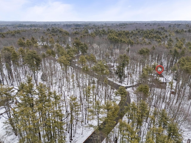 birds eye view of property featuring a view of trees