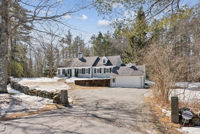 view of front of property featuring aphalt driveway and an attached garage