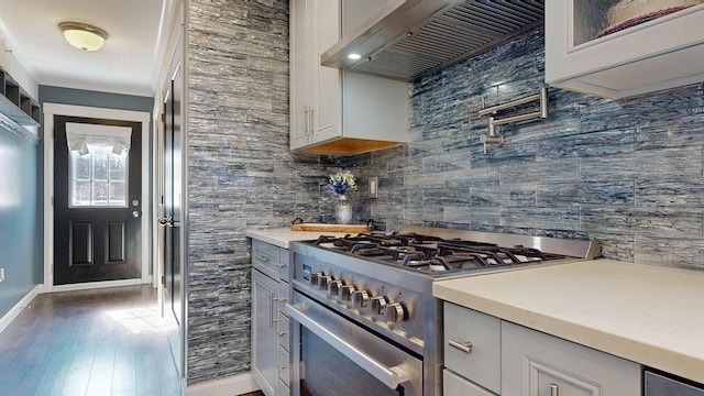 7 Dogleg Dr, Windham, ME 04062 - kitchen featuring high end range, premium range hood, backsplash, wood finished floors, and glass insert cabinets