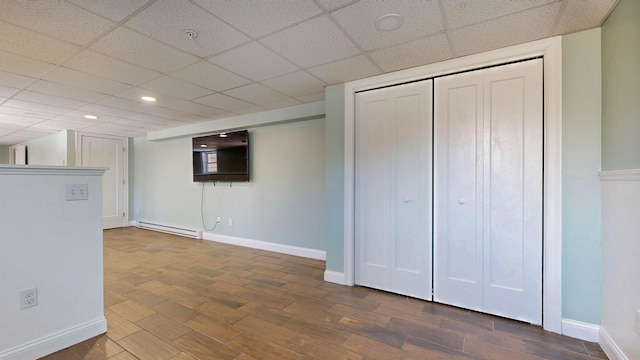 7 Dogleg Dr, Windham, ME 04062 - below grade area with baseboard heating, baseboards, a paneled ceiling, dark wood-type flooring, and recessed lighting