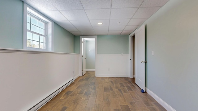 7 Dogleg Dr, Windham, ME 04062 - basement featuring baseboard heating, a paneled ceiling, wood finished floors, baseboards, and recessed lighting