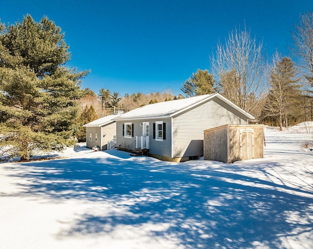 view of front of house with a shed and an outdoor structure