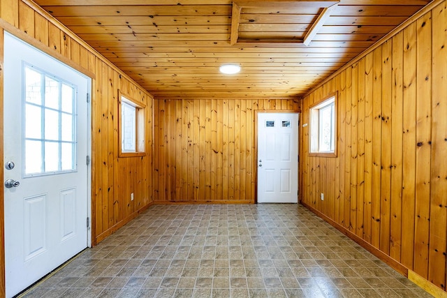 entryway with wooden ceiling and wooden walls