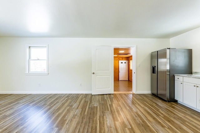 interior space featuring light wood-style floors and baseboards